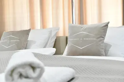 a bedroom with two pillows and a bed at Apartamenty Modrzewiowa Zator in Piotrowice