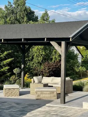 a pavilion with a couch under a black roof at Apartamenty Modrzewiowa Zator in Piotrowice
