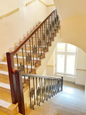 a winding staircase in a house with a window at Apartament biały z jacuzzi in Kraków