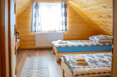 a bedroom with two beds and a window at LEŚNE ZACISZE OCHOTNICA in Ochotnica Górna