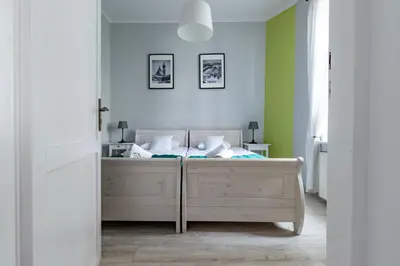a bedroom with a bed in a room with green walls at Wawel Castle Apartment in Kraków