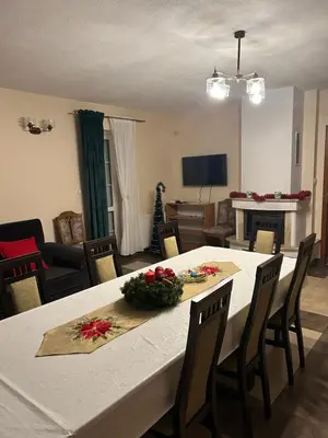 a dining room with a white table and chairs at Domek w Gaiku in Limanowa
