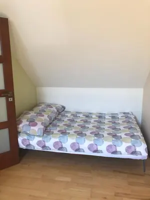 a small bedroom with a bed in a room at Domek w Gaiku in Limanowa