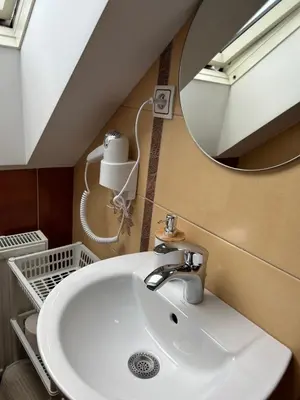 a bathroom with a sink and a mirror at Domek w Gaiku in Limanowa