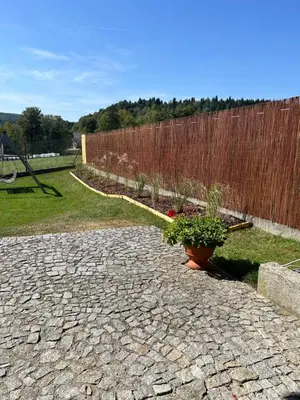 a garden with a fence and a potted plant at Domek w Gaiku in Limanowa