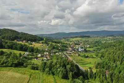 an aerial view of a small village in a green valley at Domek w Gaiku in Limanowa