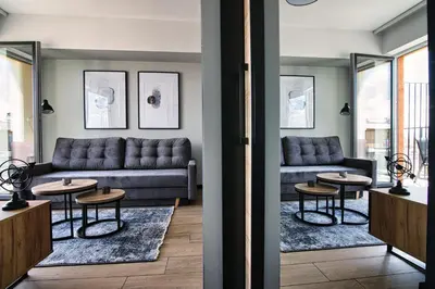 a living room with a couch and two tables at Apartament Timi Zator by Housine in Zator