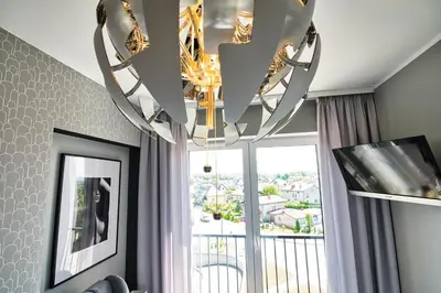 a chandelier in a living room with a window at Apartament Timi Zator by Housine in Zator