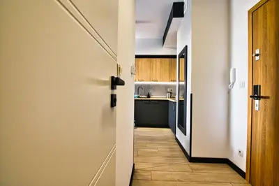 a hallway leading to a kitchen with a door at Apartament Timi Zator by Housine in Zator