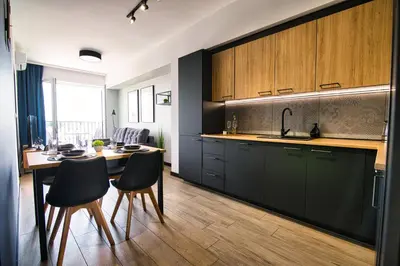 a kitchen with a table and chairs and a dining room at Apartament Timi Zator by Housine in Zator