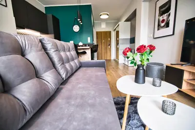 a living room with a couch and a table at Apartament Emi Zator by Housine in Zator