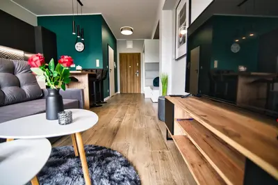 a living room with a couch and a table at Apartament Emi Zator by Housine in Zator