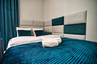 a bedroom with a bed with two pillows on it at Apartament Emi Zator by Housine in Zator