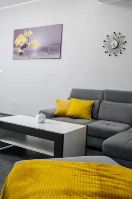 a living room with a couch and a coffee table at Apartamenty ASLux - Noclegi Energylandia Zator in Zator