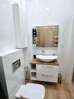 a white bathroom with a sink and a toilet at Apartamenty ASLux - Noclegi Energylandia Zator in Zator