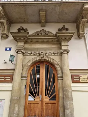 a wooden door on the side of a building at Atena - Pantheon Apartments in Kraków