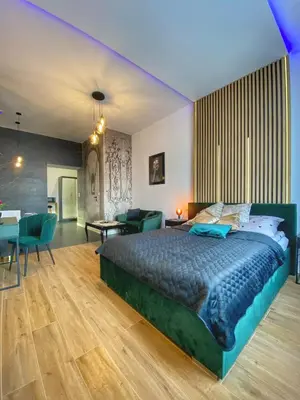 a bedroom with a large bed and a living room at Apartament czarny z jacuzzi in Kraków