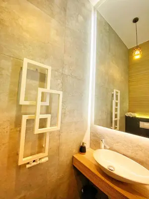 a bathroom with a sink and a mirror at Apartament czarny z jacuzzi in Kraków