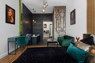 a living room with a couch and a table at Apartament czarny z jacuzzi in Kraków