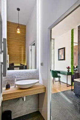 a bathroom with a sink and a mirror at Apartament czarny z jacuzzi in Kraków
