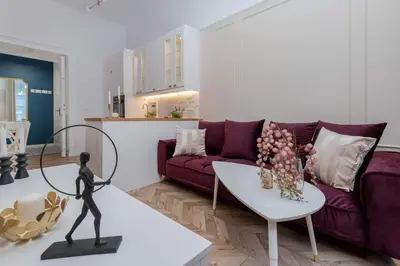 a living room with a purple couch and a table at Olver Apartment in Kraków