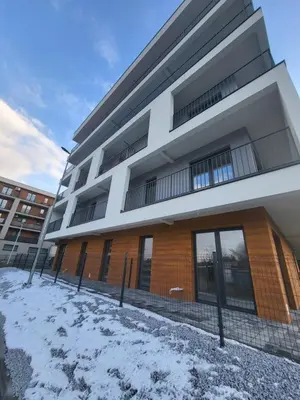 a building with snow in front of it at Nest Apartament in Zator