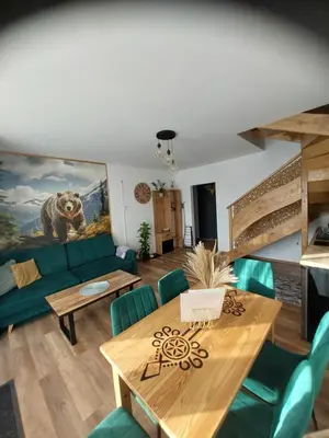 a living room with a couch and a table at Gorczański Resort Domek w Górach Sauna Jacuzzi in Nowy Targ