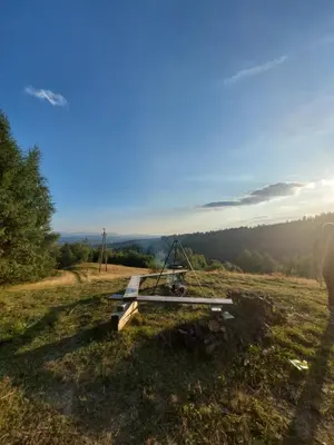 a picnic table on top of a field at Gorczański Resort Domek w Górach Sauna Jacuzzi in Nowy Targ