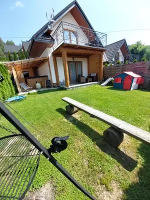 a bench in the yard of a house at Gorczański Resort Domek w Górach Sauna Jacuzzi in Nowy Targ