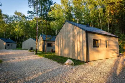a small wooden building on the side of a road at La Playa Resort & Camp Trzebinia in Trzebinia