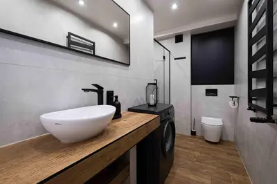 a bathroom with a sink and a washing machine at Katowicka Premium Apartment in Kraków