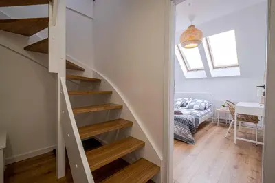 a staircase in a house with a living room at Katowicka Premium Apartment in Kraków