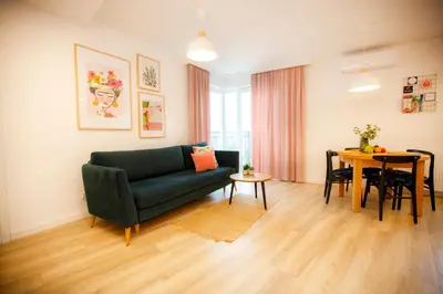 a living room with a green couch and a table at Bochenka Apartments II in Kraków