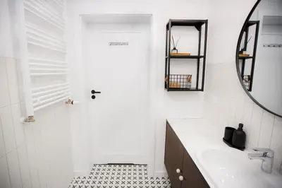 a bathroom with a sink and a mirror at Bochenka Apartments II in Kraków