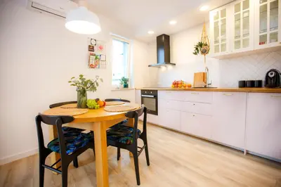 a kitchen with a table and chairs in a room at Bochenka Apartments II in Kraków