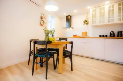 a kitchen with a wooden table and chairs at Bochenka Apartments II in Kraków