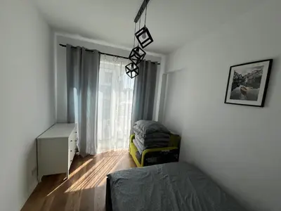 a small bedroom with a bed and a window at Apartament Marko in Zator