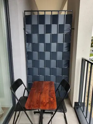 a wooden table and chair on a balcony at Apartament Marko in Zator