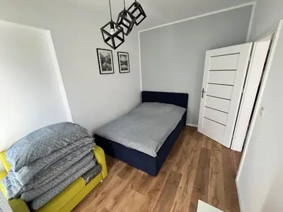 a small bedroom with a bed and a small closet at Apartament Marko in Zator