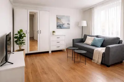 a living room with a couch and a tv at Urban Nest Apartments Szewska 21-19 in Kraków