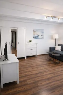 a living room with a blue couch and a table at Urban Nest Apartments Szewska 21-19 in Kraków