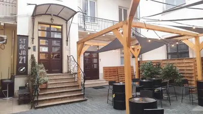 a restaurant with a table and chairs in front of a building at Urban Nest Apartments Szewska 21-19 in Kraków