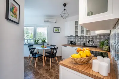 a kitchen with a table with a bowl of fruit at Apartament Nad Różami in Oświęcim