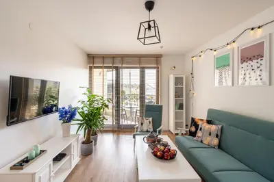 a living room with a couch and a tv at Apartament Nad Różami in Oświęcim