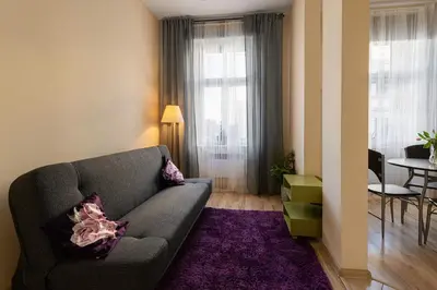 a living room with a couch and a table at Negroni Apartments Dajwor in Kraków