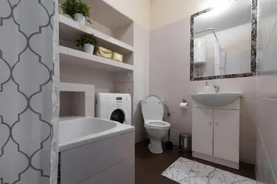 a white bathroom with a sink and a toilet at Negroni Apartments Dajwor in Kraków
