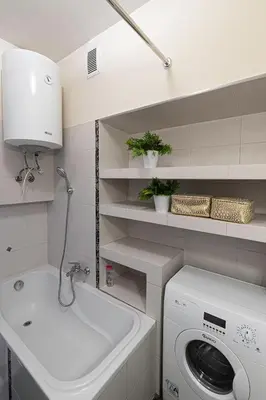 a white laundry room with a washing machine and a sink at Negroni Apartments Dajwor in Kraków
