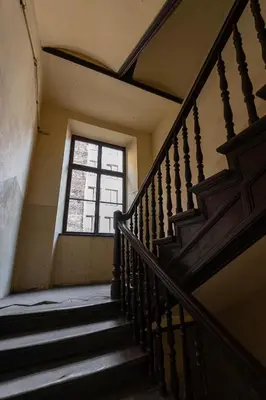 an old staircase with a window in a building at Negroni Apartments Dajwor in Kraków