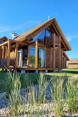 a wooden house on the beach at Domki Kuter Port in Gdów