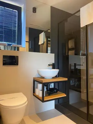 a bathroom with a sink and a toilet at Domki Kuter Port in Gdów
